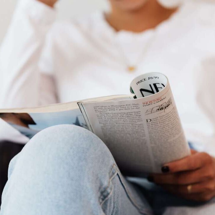 Picture of woman reading a newspaper about counseling. Our therapists are licensed in hypnosis and trauma.